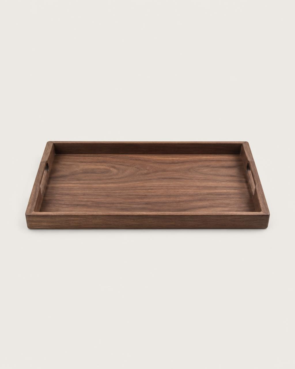 Rectangular walnut wood serving tray on a plain warm background